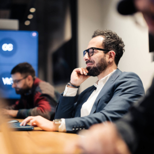 Developer working on a laptop at a shared desk